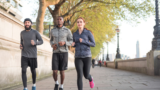 Three runners on the Embankment by the Thames in London