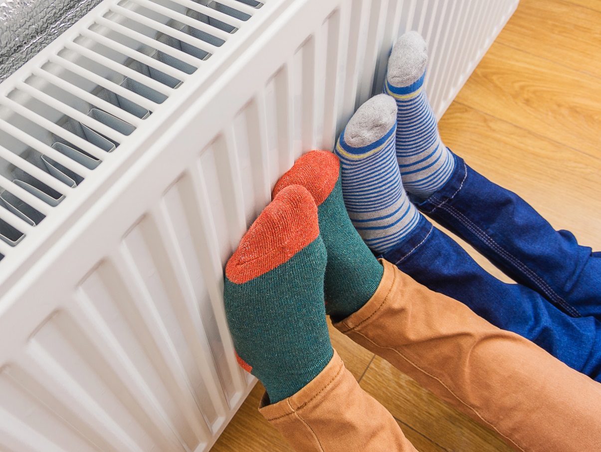 Feet in brightly coloured socks on radiator for National Grid article on Fuel Poverty Awareness Day