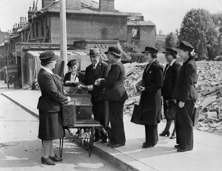 Picture of war meter readers in front of bombed houses - archive image used in the National Grid story 'Time travelling through the history of energy at the National Grid archive'