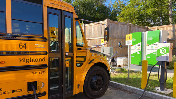 Yellow electric school bus at charging station in Beverly, Massachusetts