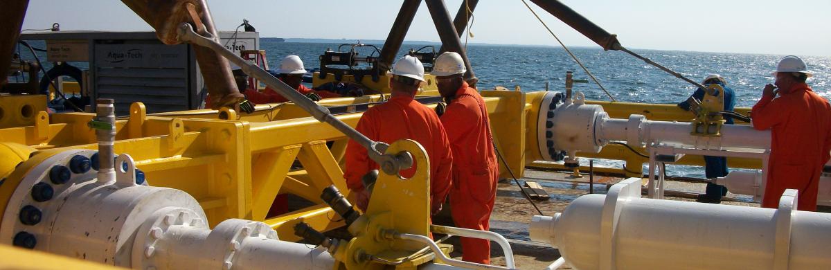 National Grid employees working on a gas rig with the ocean in the background 